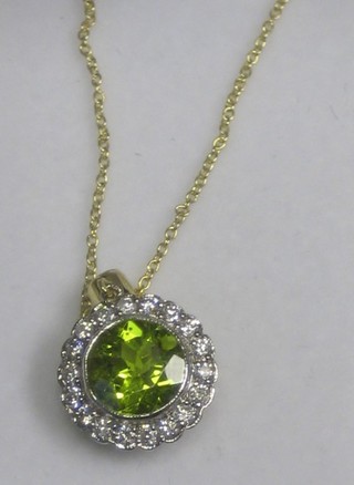 A lady's 18ct gold pendant set a circular cut peridot surrounded by diamonds, approx. 0.45/2ct