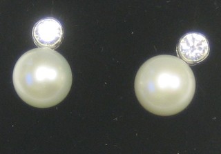 A pair of lady's pearl and diamond stud earrings approx 0.40ct