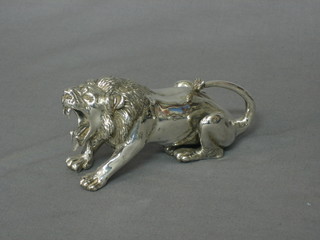 A silvered model of a seated lion, raised on a wooden base 5"