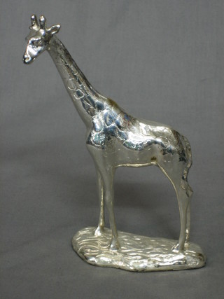 A silvered model of a standing giraffe, raised on a wooden base marked AfriSilver 7 1/2"