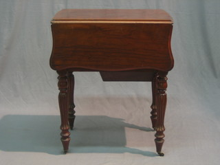 A drop flap mahogany work table, fitted 2 drawers and a cupboard, raised on turned and reeded supports 23"