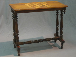 A Victorian mahogany stretcher table, the top inlaid a chessboard, raised on turned supports 30"