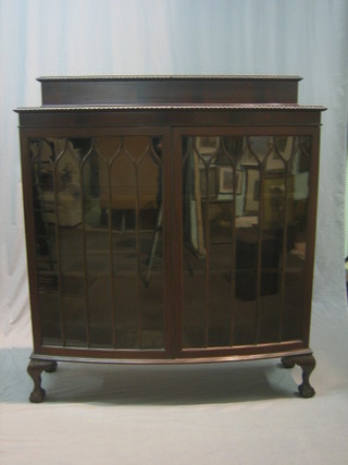 A Chippendale style mahogany bow front display cabinet, the interior fitted shelves enclosed by astragal glazed panelled doors, raised on cabriole supports 48"