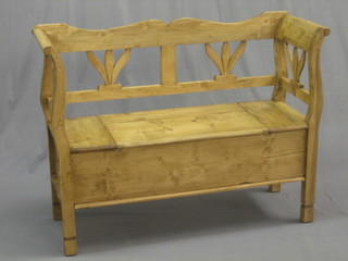 A Continental stripped and polished pine settle, the seat with hinged lid 47"