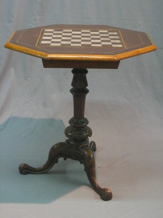 A 19th Century octagonal carved mahogany games table, the leather top inset  a chessboard, the interior containing a modern chess set, raised on a carved column with tripod base 25"