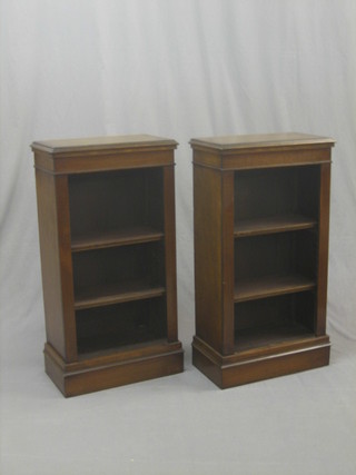 A pair of Victorian style rectangular mahogany bookcases with crossbanded tops and adjustable shelves, raised on platform bases 20"