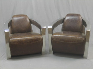 A handsome pair of Art Deco style chromium plated and leather open arm chairs