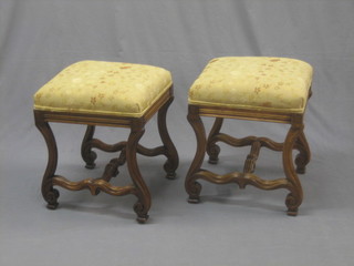 A pair of 19th Century Continental walnut stools, raised on shaped supports with X framed stretchers 16"