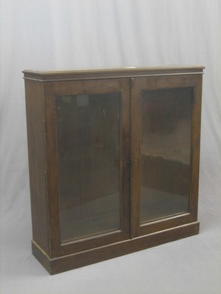 A mahogany bookcase, the interior fitted adjustable shelves enclosed by glazed panelled doors, raised on a platform base 43"