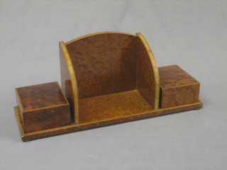 A figured walnut book trough incorporating 2 cigarette boxes with hinged lids, raised on bun feet 17"