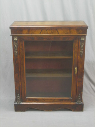 A Victorian walnut Pier cabinet fitted shelves, enclosed by a glazed panelled door, raised on a platform base 32"