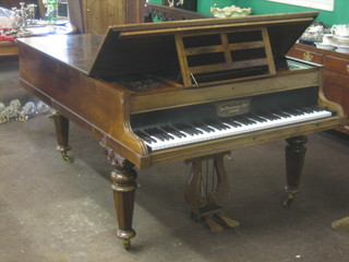 A wooden framed cottage grand piano by John Goldwin & Sons, contained in a rosewood case
