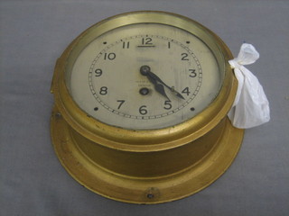 A wardroom clock by Hezzanith, having a 7" silvered dial with Roman numerals marked Heath & Co, London