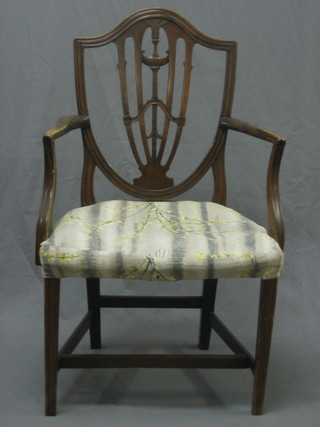A 19th Century Hepplewhite style open arm carver chair with shield shaped back, upholstered seat raised on square tapering supports