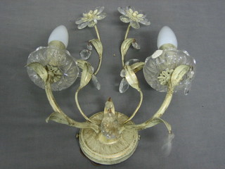 A set of 3 metal twin light wall brackets with leaf decoration hung lozenges