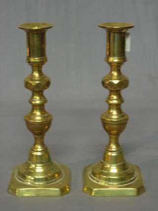 A pair of brass candlesticks with knopped stem and ejectors 7 1/2"