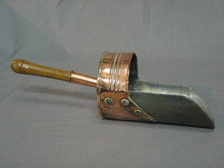 A 19th Century copper and steel coal scuttle with turned wooden handle