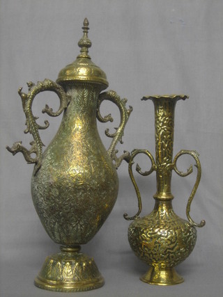 An Eastern engraved brass twin handled urn and cover 18" and a twin handled vase 13"