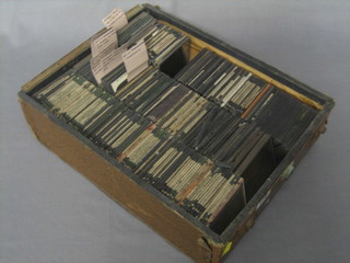 A shallow fibre box containing a collection of various Magic Lantern slides