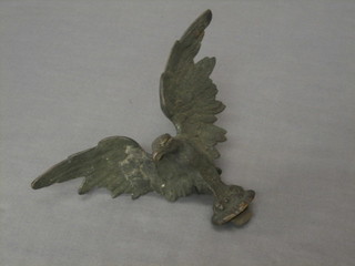 A finial/mascot in the form of a bird with wings outstretched