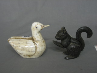 A bone figure of a duck 5" and an iron novelty nut cracker in the form of a squirrel 3"