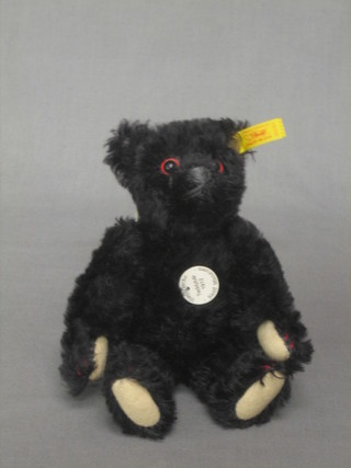 A Steiff reproduction  1912 black teddybear with articulated body 7" together with 2 Steiff cardboard boxes