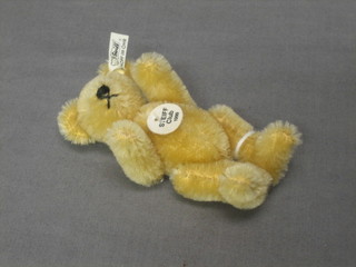 A Steiff 1999 miniature yellow teddybear with articulated limbs 4"