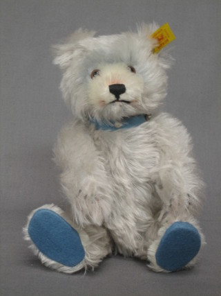 A Steiff white coloured teddybear with blue collar and pads, the label to the ear marked 006425 9"