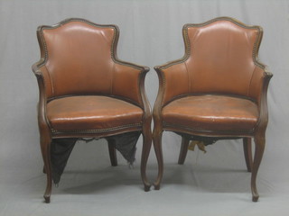 A pair of 19th Century Continental walnut show frame tub back armchairs, upholstered in rexine and raised on cabriole supports