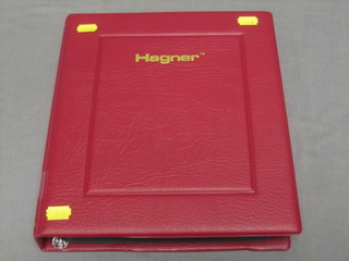 A red ring binder album of stamps GB