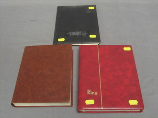 A brown stock book of various GB stamps and a red stock book of World stamps and a black stock book of World stamps