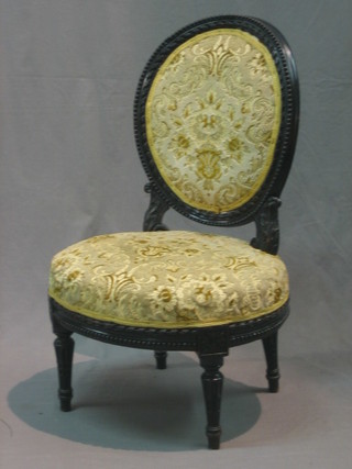 A Victorian carved ebonised salon chair with upholstered seat and back, raised on turned and fluted supports