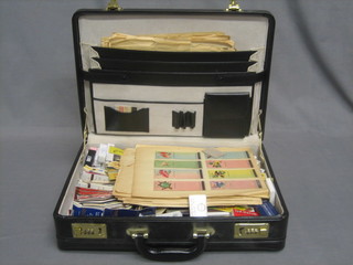 A brief case containing a collection of various match box covers