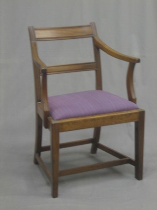 A 19th Century mahogany bar back carver chair with shaped mid rail and upholstered and drop in seat, raised on square tapering supports