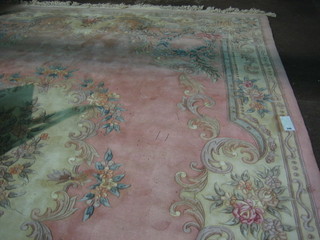 A pink ground and floral patterned Chinese rug 146" x 107"