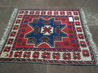 A modern Turkey blue and red ground rug with stylised star to the centre 37" x 41"