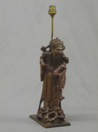 An Oriental carved root wood figure converted to an electric table lamp 13"
