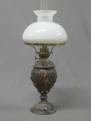 A Victorian metal oil lamp with clear glass shade and chimney
