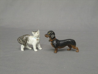 A Continental metal figure of a Dachshund 3" together with a porcelain figure of a cat (2)