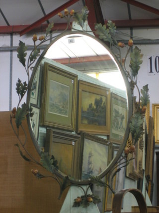 A oval plate wall mirror contained in a decorative metal frame decorated oak leaves and acorns 27" 
