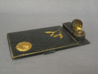 An Art Nouveau leather covered blotter with gilt metal mounts decorated head and portrait bust of a lady, having stamp box and inkwell to the side 11"