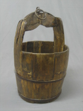 A reproduction coopered well bucket