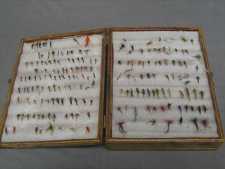 A collection of various fishing flies, boxed