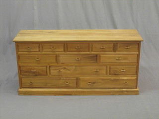An Eastern hardwood chest fitted 13 shallow drawers, raised on a platform base, 48"