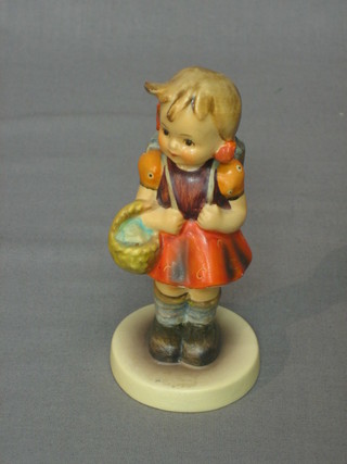A Goebel figure of a standing girl with basket and knapsack 4"