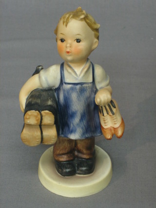 A Goebel figure of a boy cobbler with boots and ladies shoes 5"