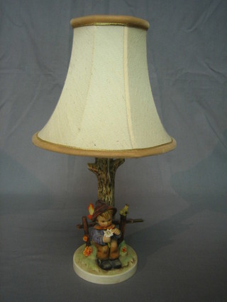 A Goebel table lamp in the form of a boy beneath a tree (chip)