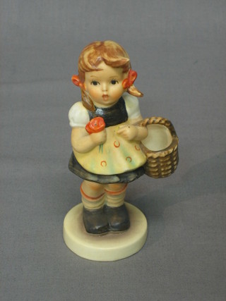 A Goebel figure of a standing girl with basket 4 1/2"