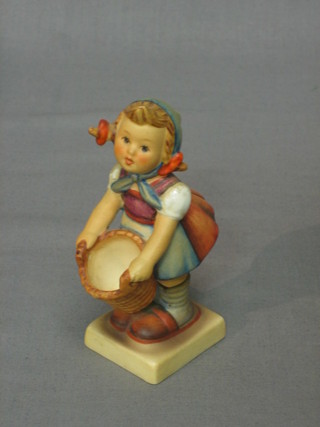 A Goebel figure of a standing girl with basket 4"