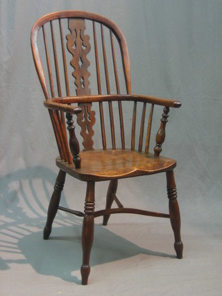 An 18th/19th Century elm and yew Windsor stick back kitchen carver chair with cow horn stretcher